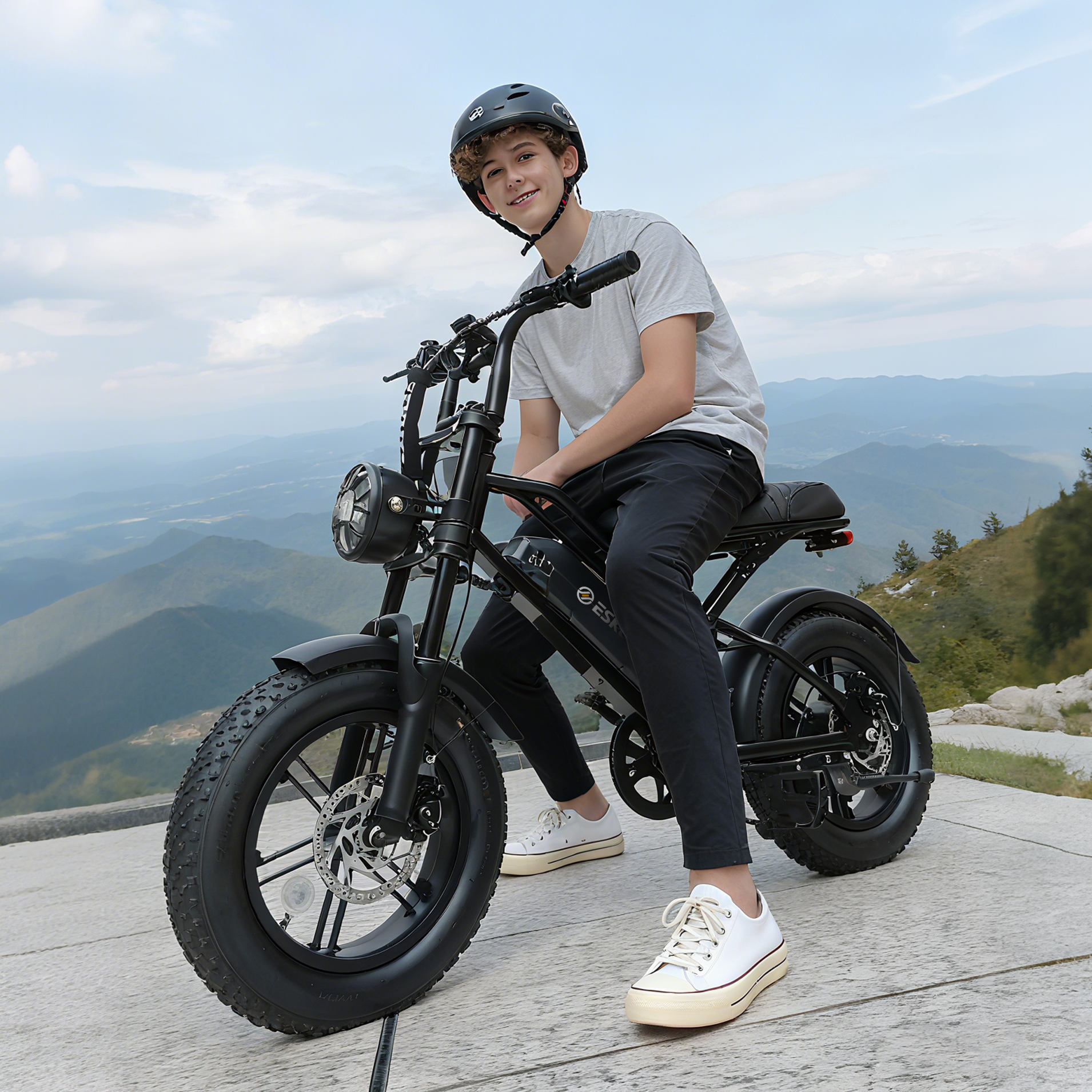 Person riding a black electric bike with a scenic mountain background